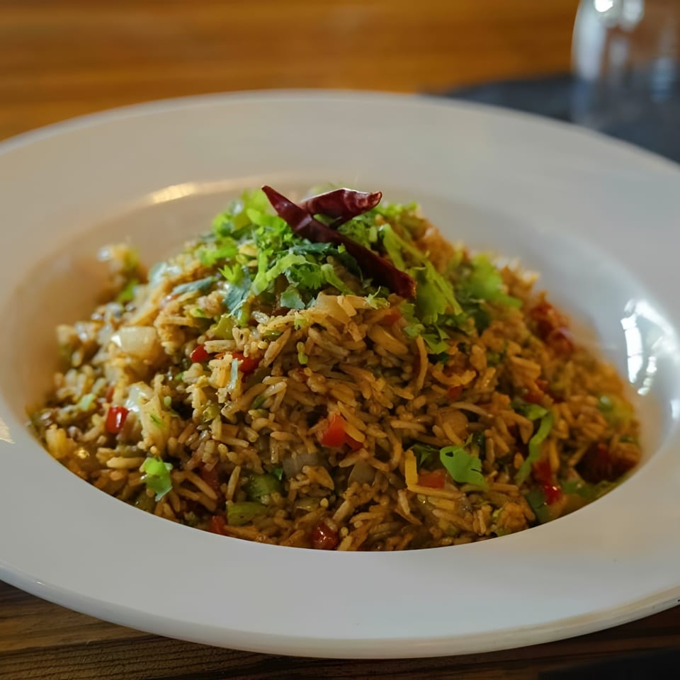 Chak De California's Indian fried rice, garnished with fresh cilantro and dried red chilies.