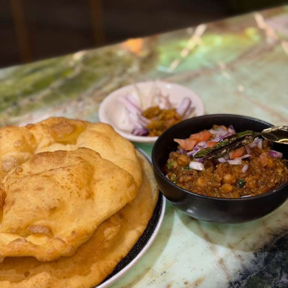 Chak De California's chole bhature, with fluffy fried bread, chickpea curry, and pickled onions.